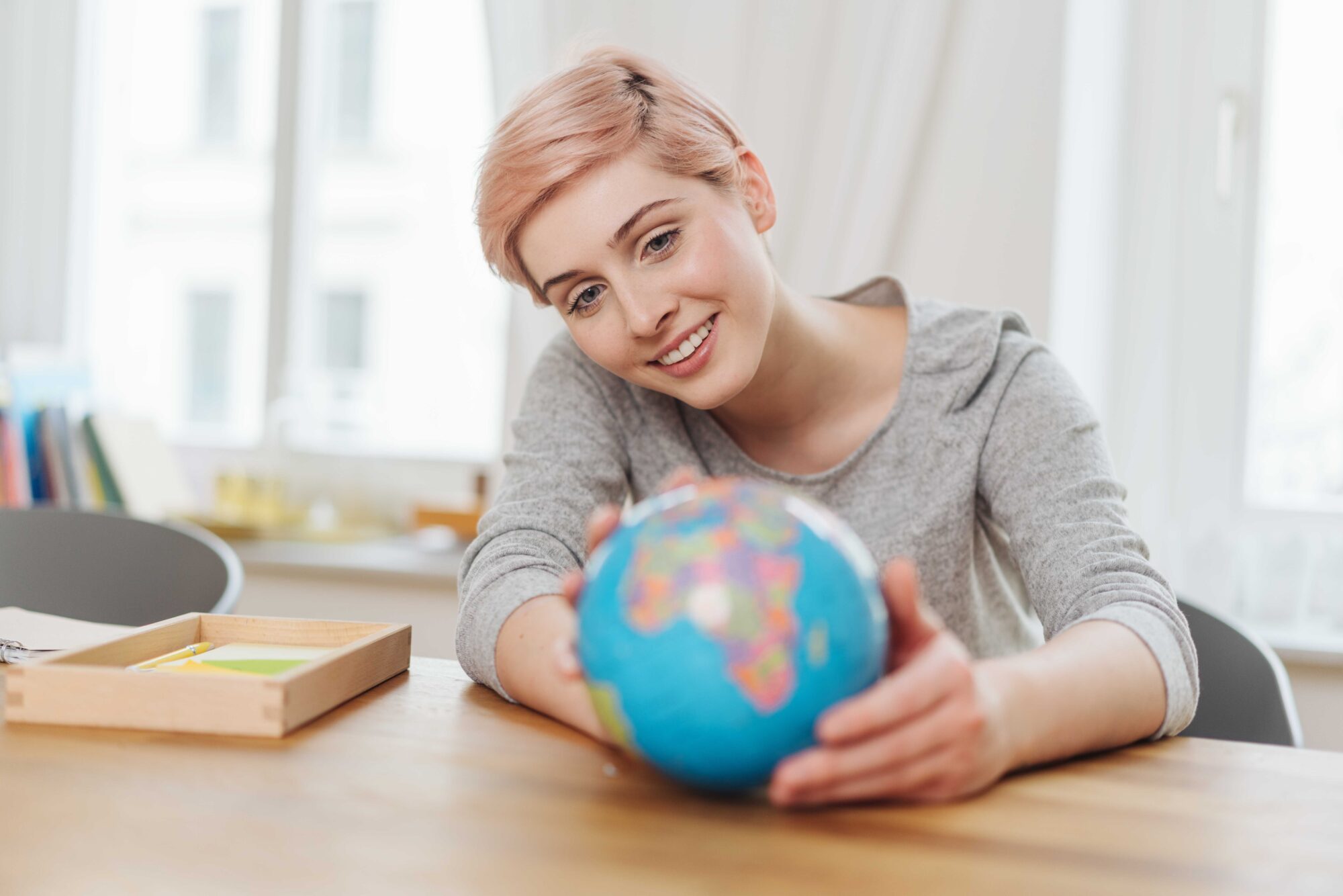 Young woman with world globe
