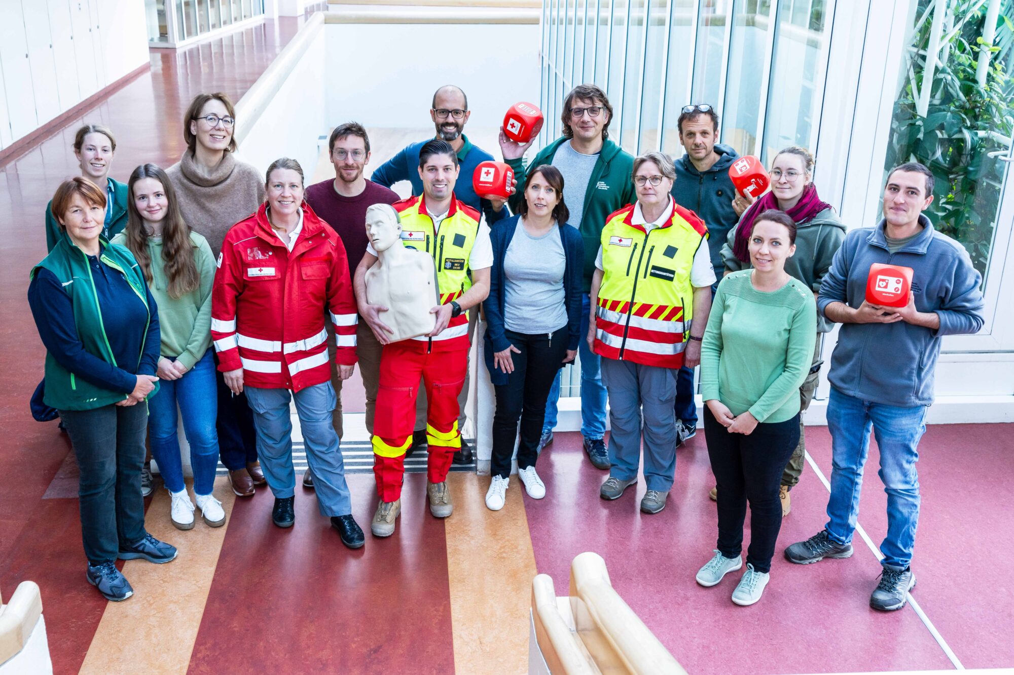 Gruppenbild mit PLUS-Mitarbeiter:innen und dem Schulungsteam des Roten Kreuzes